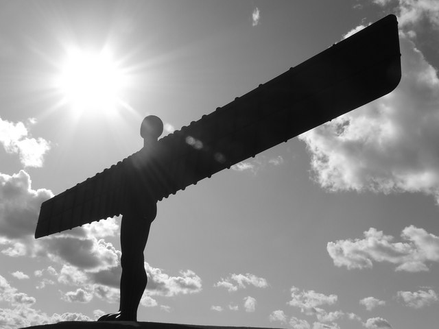 Angel of the North sculpture silhouetted against a bright sky